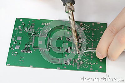 Soldering resistor to printed circuit board Stock Photo