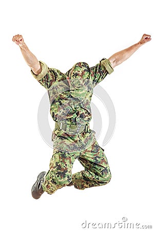 Soldie in camouflage uniform and hat jumping Stock Photo