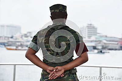 Soldier in camouflage uniforms, hands behind his backs. Editorial Stock Photo