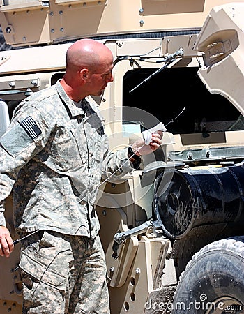 A soldier checking vehicle Stock Photo