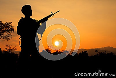 Soldier and gun in silhouette shot Stock Photo