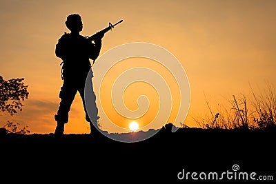 Soldier and gun in silhouette shot Stock Photo