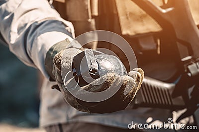 The soldier holds in his hand a training grenade while passing military exercises Stock Photo