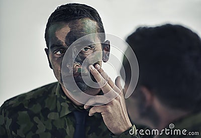 Soldier, man and face in mirror with camouflage paint with thinking, decision or brave to fight war. Person, agent or Stock Photo