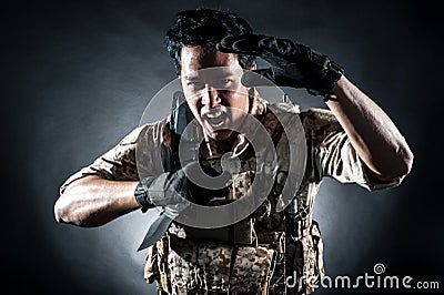 Soldier man hold Machine gun style fashion Stock Photo