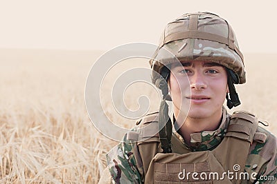 Soldier man standing against a field Stock Photo
