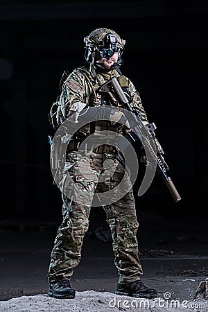 Soldier with night vision device and rifle Stock Photo