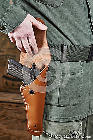 Soldier opens pistol holster Stock Photo