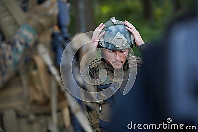 Soldier preparing tactical and commpunication gear for action battle Stock Photo