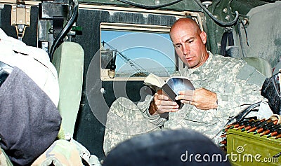 A soldier reading a book Stock Photo