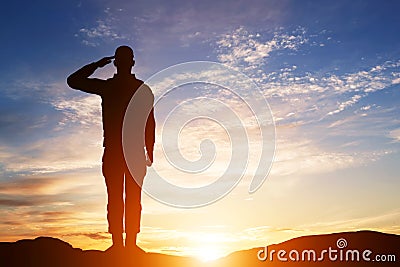 Soldier salute. Silhouette on sunset sky. Army, military. Stock Photo