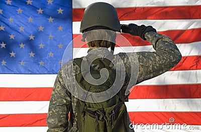 Soldier Saluting In Front Of American Flag Stock Photo