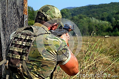 Soldier shooting with Kalashnikov assault rifle Editorial Stock Photo