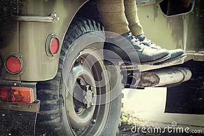 Soldier sitting on the jeep Stock Photo