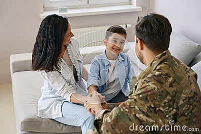 Soldier spending time with his family at home Stock Photo