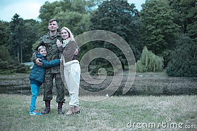 Soldier spending time with his wife and son Stock Photo