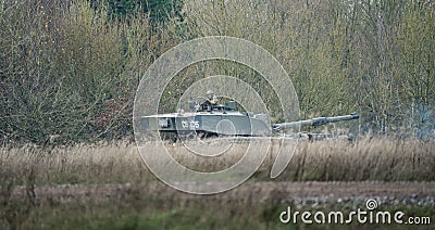 Soldier in a tank surrounded by trees Editorial Stock Photo