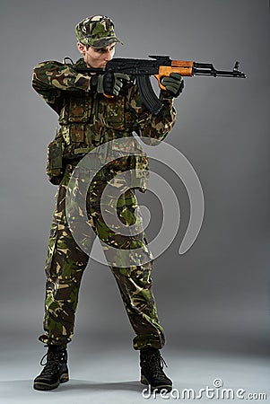 Soldier in uniform with machine gun Stock Photo