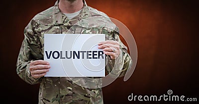 Soldier volunteer mid section against brown wall Stock Photo