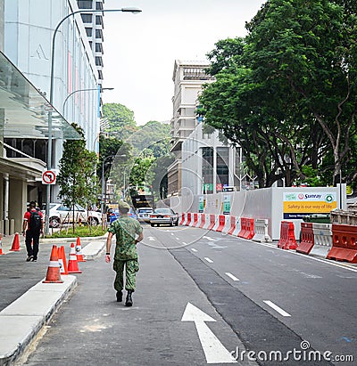 A soldier walking on street in Singapore Editorial Stock Photo