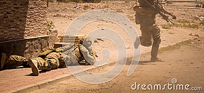 Soldiers in action in conflict zone V Stock Photo