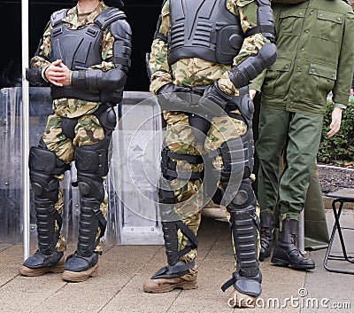 Soldiers in armored uniform and boots Stock Photo