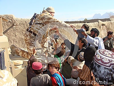 Soldiers bringing help in Afghanistan Editorial Stock Photo