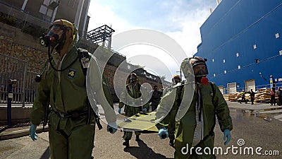 Soldiers carry stretchers to help injured person Editorial Stock Photo