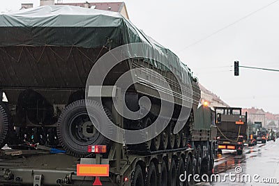 Soldiers of Czech Army are riding military truck with floating transporter Stock Photo