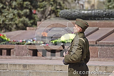 Soldiers of honor guard with a gun in his hand shall be on duty at eternal flame Editorial Stock Photo