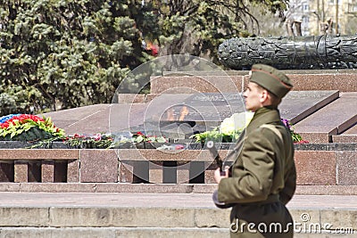 Soldiers of honor guard with a gun in his hand shall be on duty at eternal flame Editorial Stock Photo