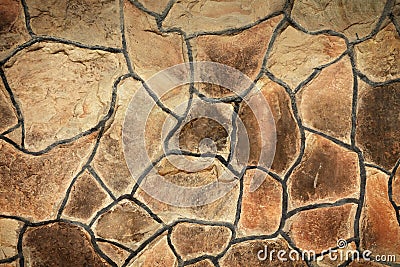 Solid brown and beige stone wall. Suitable for background. Stock Photo