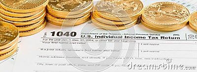Solid gold coins on 2014 form 1040 Editorial Stock Photo
