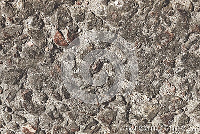 Solid grey granite stone is lying on the sand Stock Photo