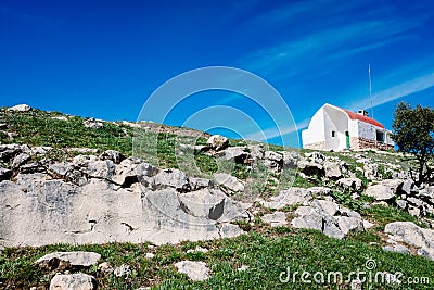 Solid mountain lodge on top of a rocky ridge Stock Photo