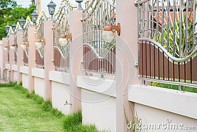 Solid Privacy stainless steel fence luxurious contemporary decorative light fixtures. Stock Photo
