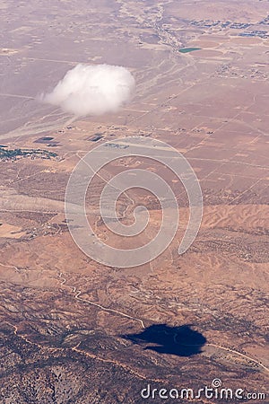 A solitary cloud and its shadow over the desert Stock Photo