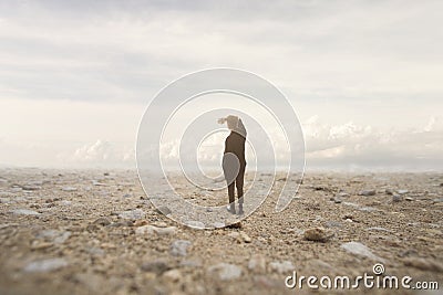 Solitary man looks at the infinite in a surreal and spectacular landscape Stock Photo