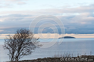 Solitude blue island in calm water Stock Photo