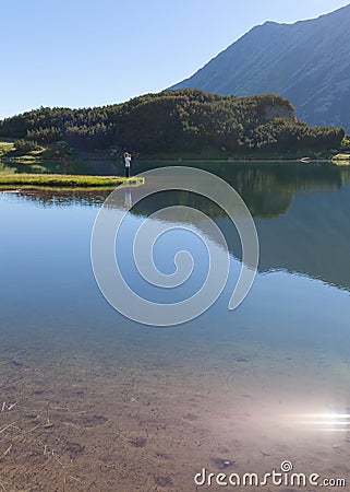 Solitude girl mountaineer taking a photo in nature Stock Photo