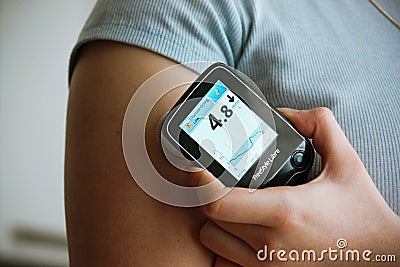 Diabetic patient measuring her blood glucose with freestyle libre Editorial Stock Photo
