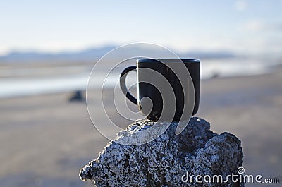 Solo blank black coffee mug at sunset on a wooden post Stock Photo