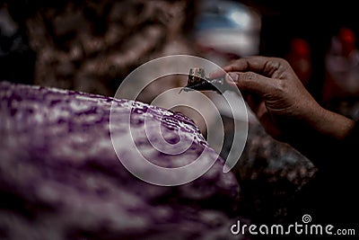 Close Up hand and canting, making batik Tulis Indonesia Stock Photo