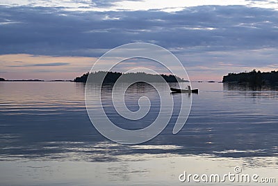 Solo paddling a canoe at dusk in Thirty-Thousand Islands, Ontario Stock Photo