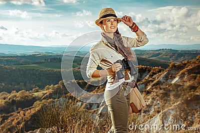 Solo traveller woman with binoculars looking into the distance Stock Photo