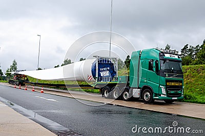 Soltau, Germany - August 28, 2021: Wind turbine blade transportation on truck Editorial Stock Photo