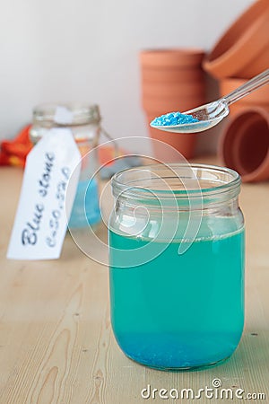 Solution of copper sulphate in glass jar Stock Photo