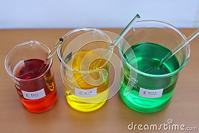 Solutions of food dyes in a beakers. Stock Photo