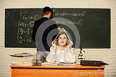 Solving task. Man writing on chalkboard math formulas. Teaching in university. High school. University education Stock Photo