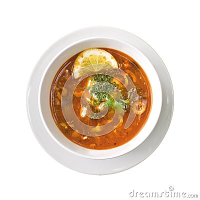 Solyanka soup in the plate, isolated on white background. Top view Stock Photo